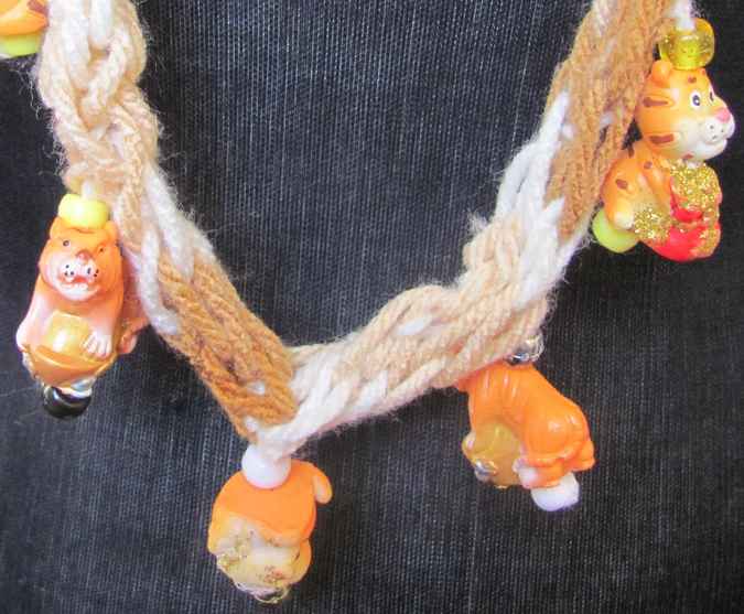 large image of art item: accessory – necklace crochet orange white flower animals wooden