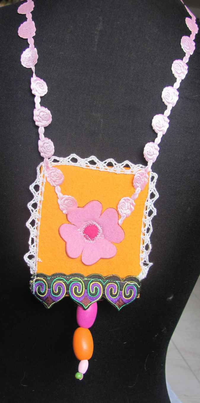 large image of art item: accessory – felt necklace with pink flower on yellow background