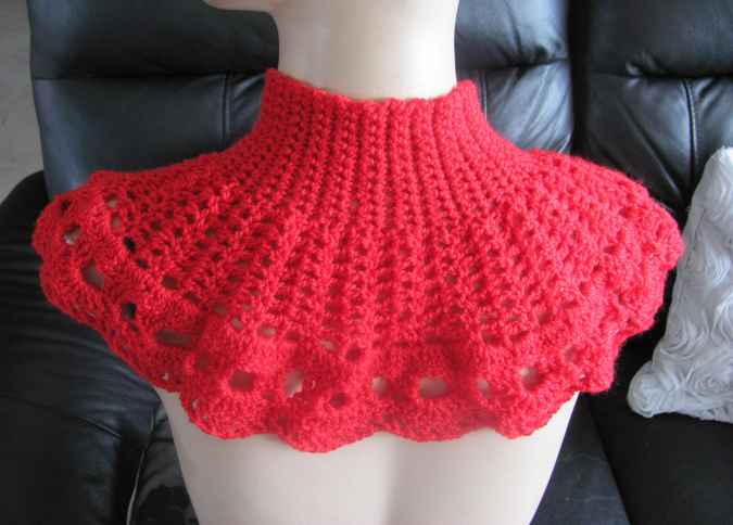 large image of art item: red crocheted capelet with golden button
