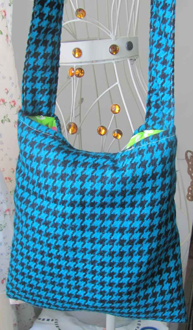 large image of art item: bag – checkred blue black motif leaves green white crochet flowers red pink