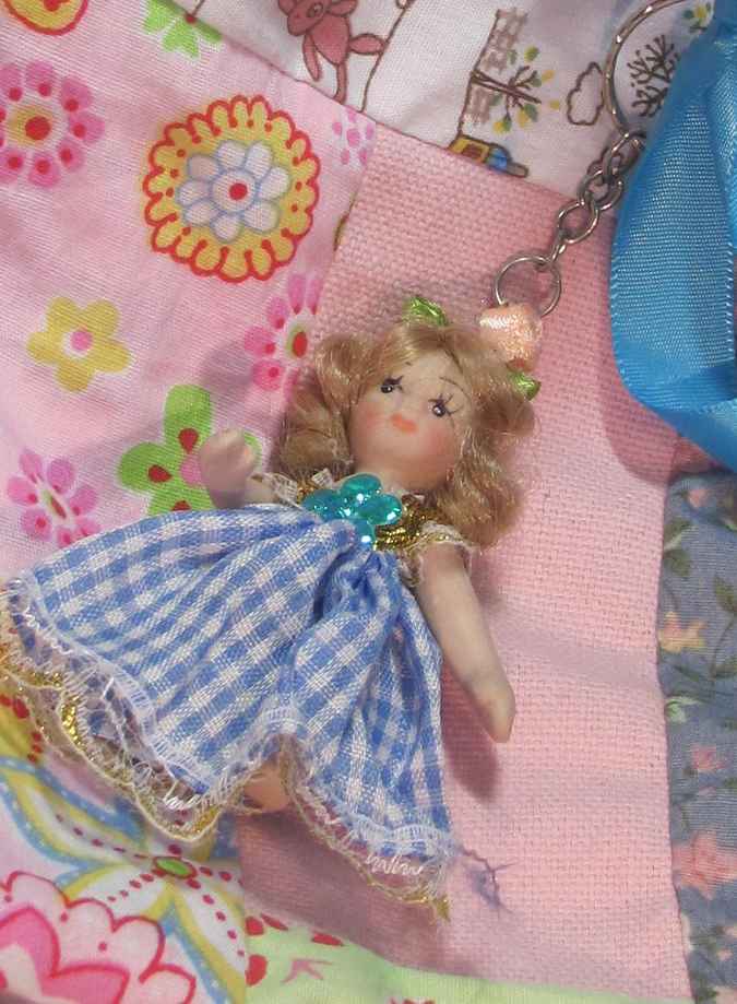 large image of art item: bag – doll and blue ribbon