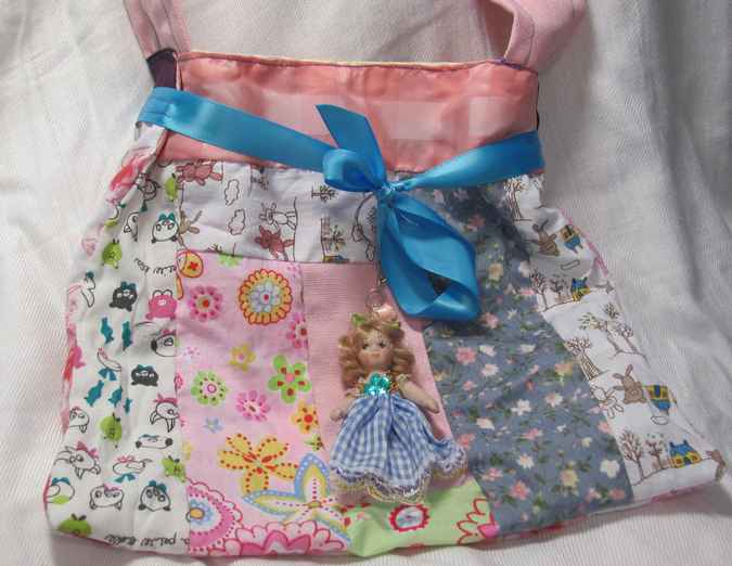 large image of art item: bag – doll and blue ribbon