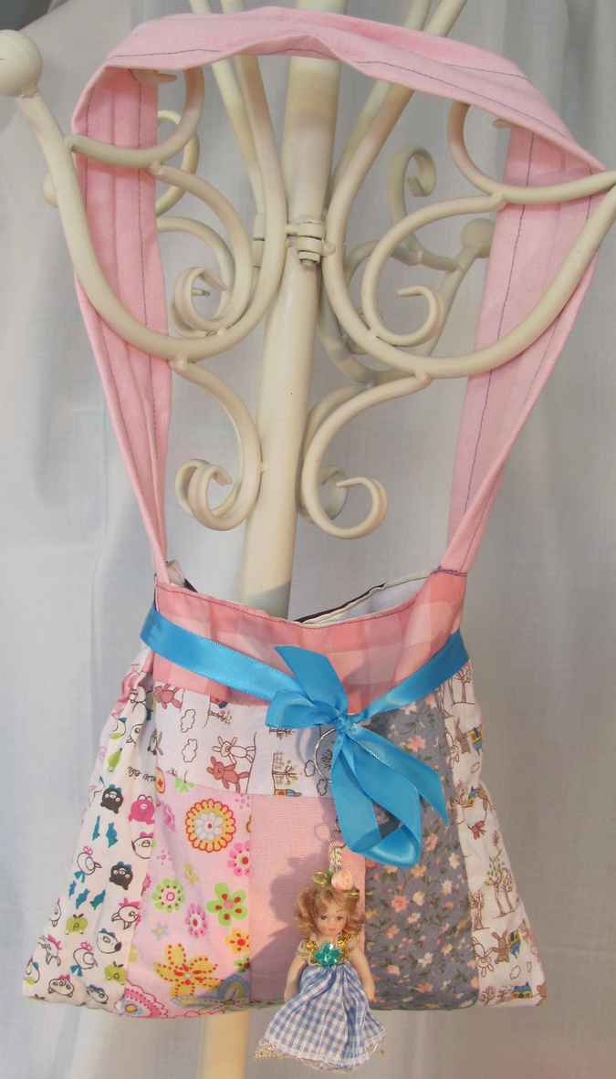 large image of art item: bag – doll and blue ribbon
