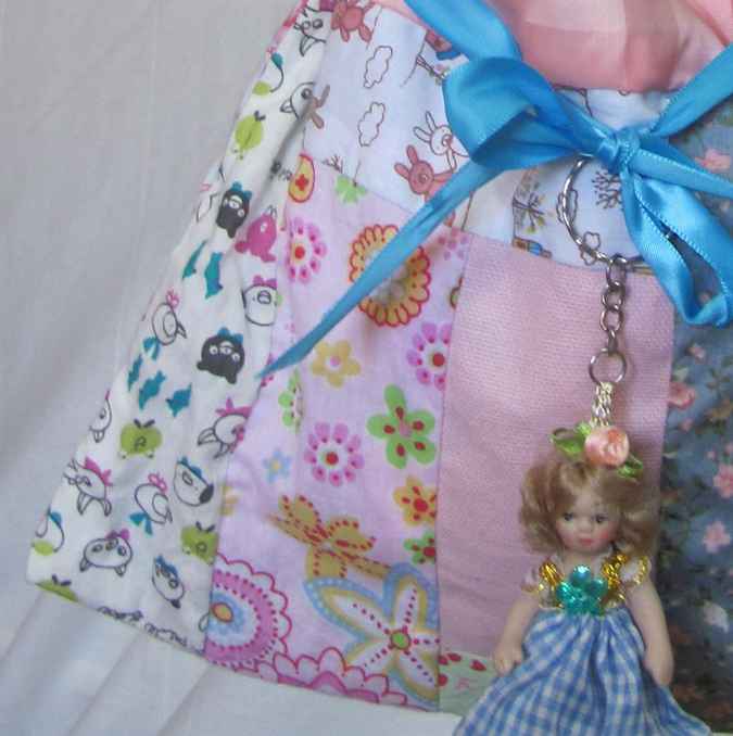 large image of art item: bag – doll and blue ribbon