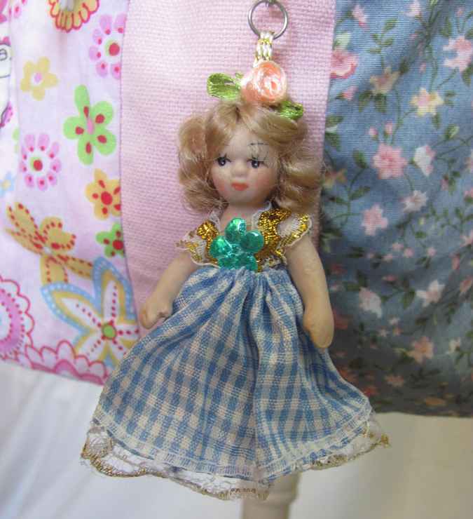 large image of art item: bag – doll and blue ribbon