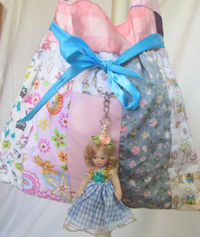 large image of art item: bag – doll and blue ribbon