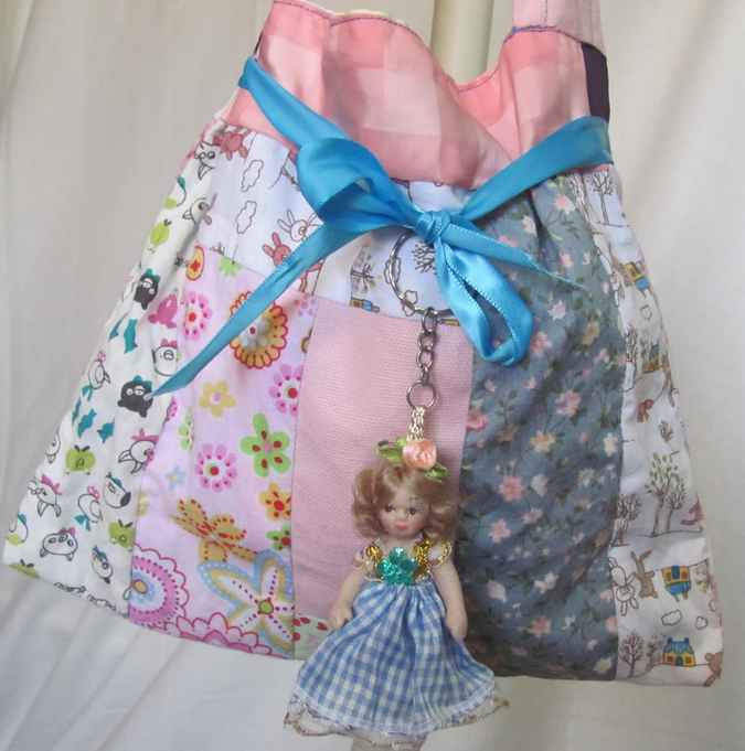 large image of art item: bag – doll and blue ribbon