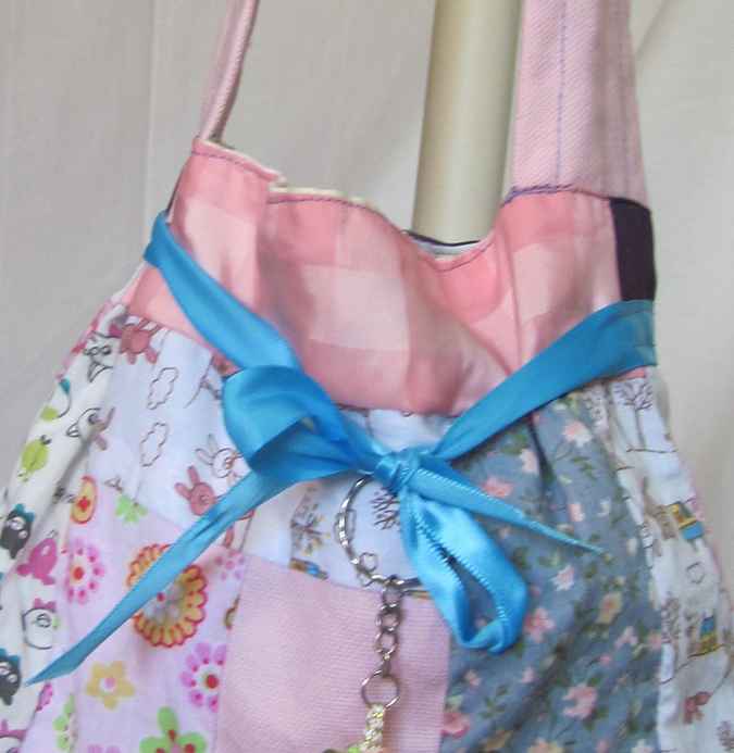 large image of art item: bag – doll and blue ribbon