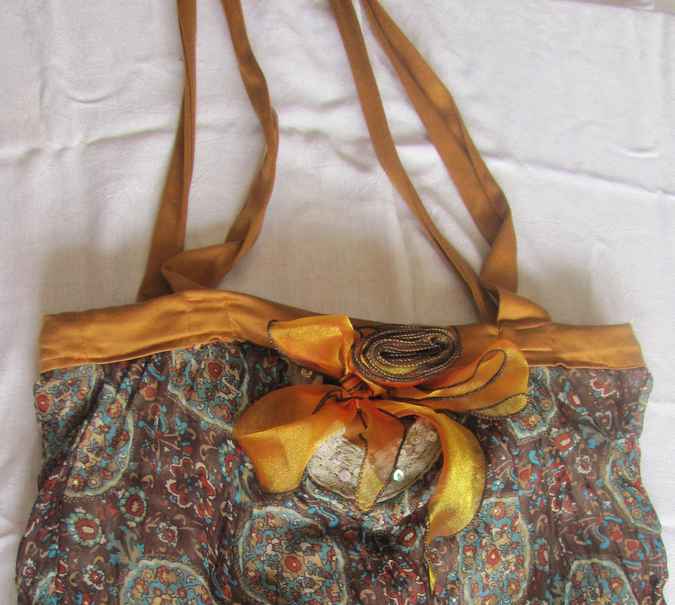 large image of art item: bag – flowers circles texture ribbon gold
