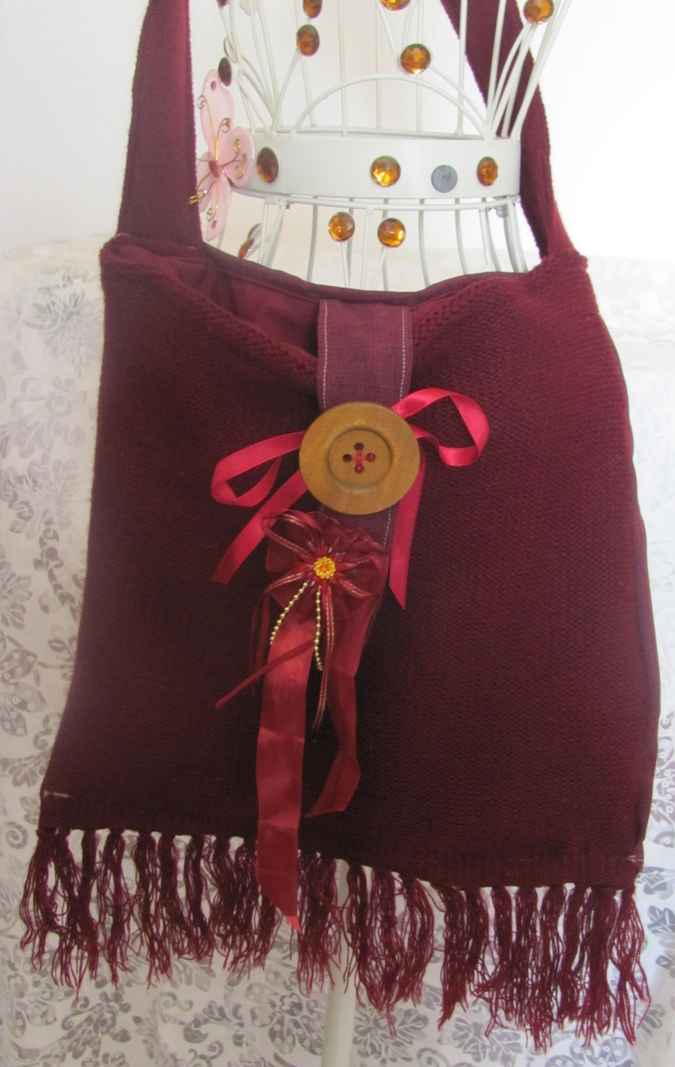 large image of art item: bag – fabric crimson button brown hairs
