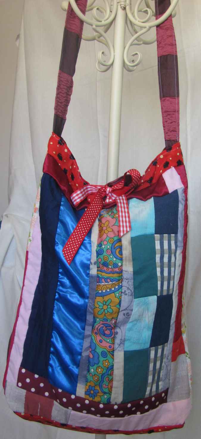 large image of art item: bag – quiltwork red blue with red ribbons