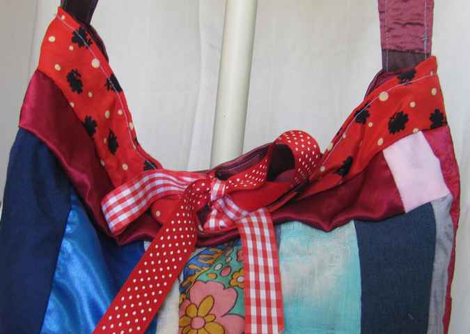 large image of art item: bag – quiltwork red blue with red ribbons