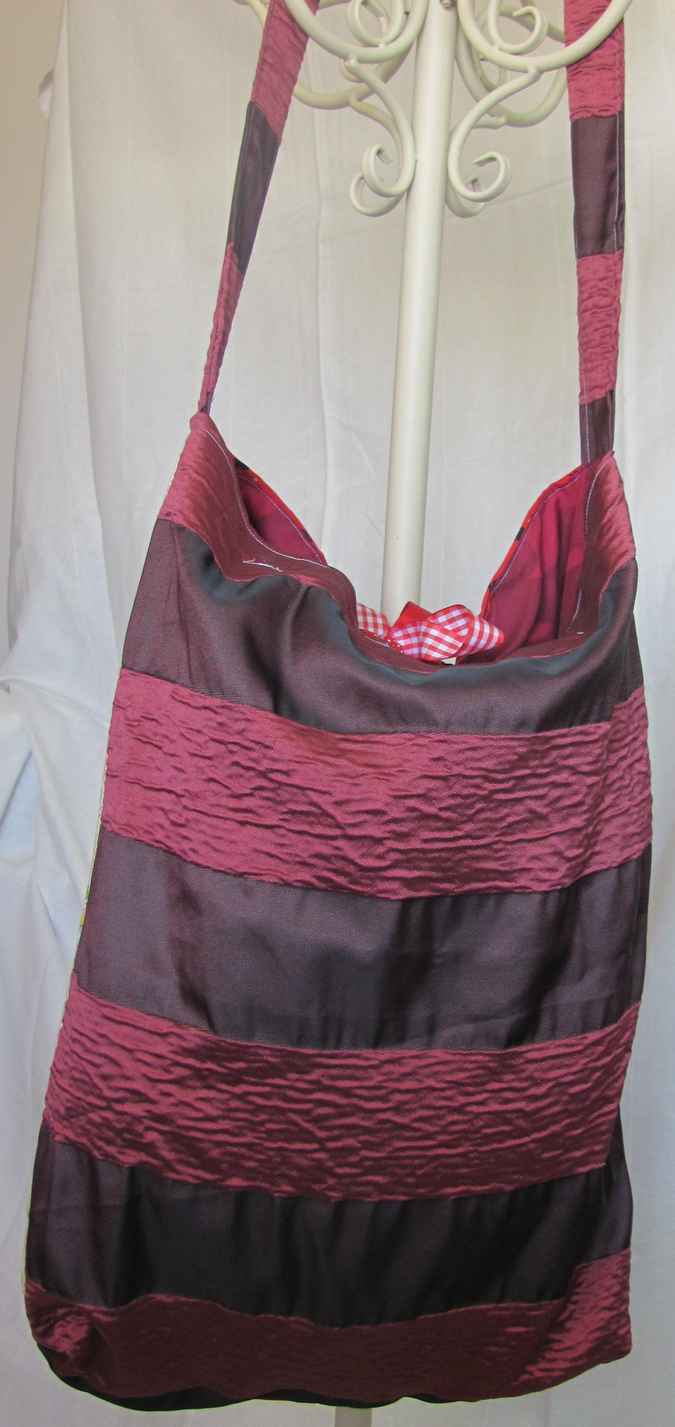 large image of art item: bag – quiltwork red blue with red ribbons