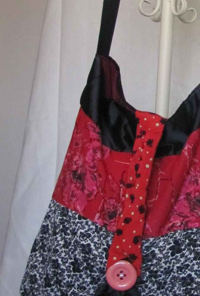 large image of art item: bag – red black white flower motif with pink button