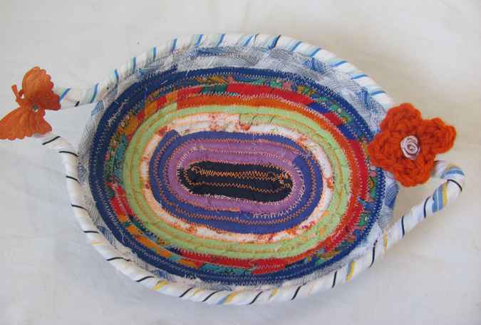 large image of art item: basket – small purple green blue with orange butterfly and flower