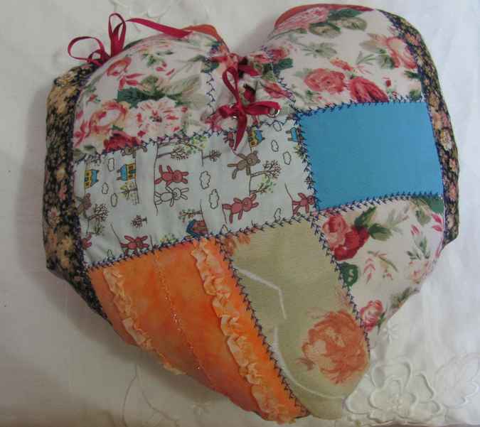 large image of art item: heart shaped quilted pillow with ribbon